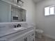 Bathroom with modern vanity, granite countertop, black hardware, and tiled shower with glass enclosure at 2790 W Cholla St, Apache Junction, AZ 85120