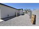 Side yard view showcasing stucco exterior, rock groundcover, and block wall at 2790 W Cholla St, Apache Junction, AZ 85120