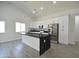 Bright kitchen features white cabinets, stainless steel appliances, and a large island with black marble countertop at 2790 W Cholla St, Apache Junction, AZ 85120