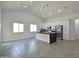Spacious living area with tile floors, vaulted ceilings, modern lighting fixtures, and a stylish black marble kitchen island at 2790 W Cholla St, Apache Junction, AZ 85120