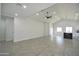 The open-concept living space features tile flooring, a modern ceiling fan, and vaulted ceilings for an airy feel at 2790 W Cholla St, Apache Junction, AZ 85120