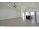 Open-concept living room features tile flooring, vaulted ceilings, an island with black marble countertop and modern lighting at 2790 W Cholla St, Apache Junction, AZ 85120