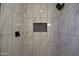 Shower featuring marble tile, black fixtures, a shower niche, and a modern shower head at 2790 W Cholla St, Apache Junction, AZ 85120