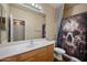 Bathroom with decorative shower curtain, vanity with sink, and a well-lit mirror at 3147 E Vallejo Dr, Gilbert, AZ 85298