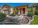 Inviting covered front porch framed by decorative columns and lush tropical landscaping at 3147 E Vallejo Dr, Gilbert, AZ 85298