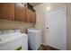 Laundry room with a washer, dryer, storage cabinets, and access to the exterior at 3147 E Vallejo Dr, Gilbert, AZ 85298