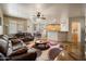 Open-concept living room featuring leather sofas, stylish rug, and easy access to the kitchen at 3147 E Vallejo Dr, Gilbert, AZ 85298