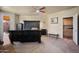 The large main bedroom features a large dark wooden bed, ceiling fan, and ensuite bath at 3147 E Vallejo Dr, Gilbert, AZ 85298