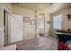 Bright and airy main bedroom with neutral carpet, leading to bathroom, and a glimpse of furniture accents at 3147 E Vallejo Dr, Gilbert, AZ 85298