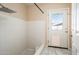 Minimalist tiled shower with a glass-panelled door for natural light, and a secondary door with a pet door at 333 E Caribbean Ln, Phoenix, AZ 85022