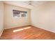 Bright bedroom featuring wood-look floors and a window offering natural light at 333 E Caribbean Ln, Phoenix, AZ 85022