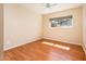 Well-lit bedroom features wood-look floors and a large window bringing the outdoors in at 333 E Caribbean Ln, Phoenix, AZ 85022
