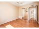 Cozy bedroom with a ceiling fan, wood-look floors, and mirrored closet doors at 333 E Caribbean Ln, Phoenix, AZ 85022