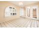 Charming dining room with arched shutter window, elegant lighting, and tiled floors for a bright, inviting space at 333 E Caribbean Ln, Phoenix, AZ 85022