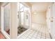 Bright entryway featuring an open atrium, tiled floors, and a chandelier-lit dining area in the background at 333 E Caribbean Ln, Phoenix, AZ 85022