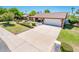 Well-maintained home with a spacious driveway, lush front yard and mature landscaping at 333 E Caribbean Ln, Phoenix, AZ 85022