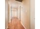 Long hallway featuring hardwood floors, neutral paint, and access to multiple rooms at 333 E Caribbean Ln, Phoenix, AZ 85022
