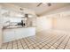 Well-lit kitchen has stainless steel appliances, white cabinets, and tile flooring extending into the living area at 333 E Caribbean Ln, Phoenix, AZ 85022
