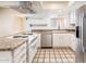 Bright kitchen featuring white cabinets, stainless steel appliances, and tiled countertops at 333 E Caribbean Ln, Phoenix, AZ 85022