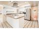 Well-lit kitchen with white cabinets, stainless steel refrigerator and tiled countertops at 333 E Caribbean Ln, Phoenix, AZ 85022
