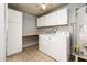 A functional laundry area features neutral tones, tile flooring, and ample storage space at 333 E Caribbean Ln, Phoenix, AZ 85022