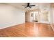 Open living room featuring hardwood floors, neutral walls, a ceiling fan, and a view to an atrium at 333 E Caribbean Ln, Phoenix, AZ 85022