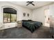 Bright bedroom featuring a window view, ceiling fan, and carpeted floors at 33823 N 2Nd St, Phoenix, AZ 85085