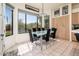 Bright dining area featuring a large glass table with modern chairs, and abundant natural light at 33823 N 2Nd St, Phoenix, AZ 85085