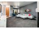 Modern living room featuring carpet flooring, a large sectional sofa, and a bay window at 33823 N 2Nd St, Phoenix, AZ 85085