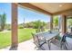 Inviting covered patio with dining set overlooking the lush backyard, perfect for entertaining at 33823 N 2Nd St, Phoenix, AZ 85085