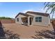 Rear exterior with a covered patio and low-maintenance gravel landscaping, ideal for outdoor living and entertaining at 37166 N El Morro Trl, San Tan Valley, AZ 85140