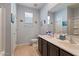 Bathroom featuring double sinks with spacious countertop and vanity, tile floor, toilet and shower at 37166 N El Morro Trl, San Tan Valley, AZ 85140