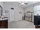 Spacious bedroom with neutral carpeting, ceiling fan, and ample space for furniture arrangement at 37166 N El Morro Trl, San Tan Valley, AZ 85140