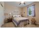 Comfortable bedroom with a queen-sized bed, side tables, and a window providing natural light at 37166 N El Morro Trl, San Tan Valley, AZ 85140