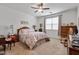 Comfortable bedroom with neutral colors, ceiling fan, and a queen-sized bed, perfect for relaxation at 37166 N El Morro Trl, San Tan Valley, AZ 85140