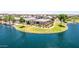 A beautiful aerial view highlights a waterfront home with well-maintained landscaping and stunning water views at 37456 W Vera Cruz Dr, Maricopa, AZ 85138