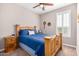 Comfortable bedroom with plush carpet, a ceiling fan, and classic wood furniture at 37456 W Vera Cruz Dr, Maricopa, AZ 85138