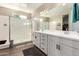 Bright main bathroom with dual sinks, a glass shower, and modern fixtures at 37456 W Vera Cruz Dr, Maricopa, AZ 85138