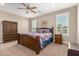 Serene main bedroom featuring wood furniture, soft natural light, and tranquil decor at 37456 W Vera Cruz Dr, Maricopa, AZ 85138