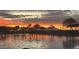 Sunset view over the pond, offering tranquil waterfront views, walking paths and picturesque setting at 37456 W Vera Cruz Dr, Maricopa, AZ 85138