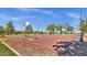 Outdoor basketball court surrounded by lush greenery and seating, perfect for friendly games at 3863 S Posse Trl, Gilbert, AZ 85297