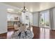 Bright dining area featuring a glass-top table, stylish chairs, and sliding glass doors to the patio at 3863 S Posse Trl, Gilbert, AZ 85297