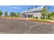 Community center building with stone accents, metal roof, and manicured landscaping at 3863 S Posse Trl, Gilbert, AZ 85297