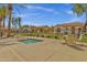 Community hot tub with tables and chairs with desert landscaping and views of the community buildings at 3863 S Posse Trl, Gilbert, AZ 85297