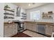 Well-lit kitchen with stainless steel appliances, open shelving, and granite countertops at 3863 S Posse Trl, Gilbert, AZ 85297