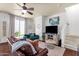 Bright and airy living room featuring hardwood floors, comfortable furnishings, and access to outdoor patio at 3863 S Posse Trl, Gilbert, AZ 85297