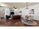 Open-concept living room with hardwood floors, modern furnishings, and ample natural light at 3863 S Posse Trl, Gilbert, AZ 85297