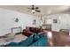 Cozy living room featuring hardwood floors, neutral walls, and an open layout leading to the kitchen at 3863 S Posse Trl, Gilbert, AZ 85297