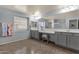 Large main bathroom with a spacious shower, a window, double sinks, and a vanity area with stool at 3863 S Posse Trl, Gilbert, AZ 85297