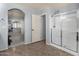 Bright main bathroom featuring a shower, and an arched alcove to the bedroom and access to the closet area at 3863 S Posse Trl, Gilbert, AZ 85297